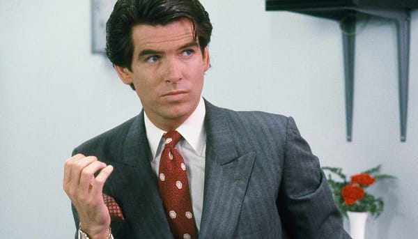 Pierce Brosnan as Remington Steele, looking suave in his '80s power suit